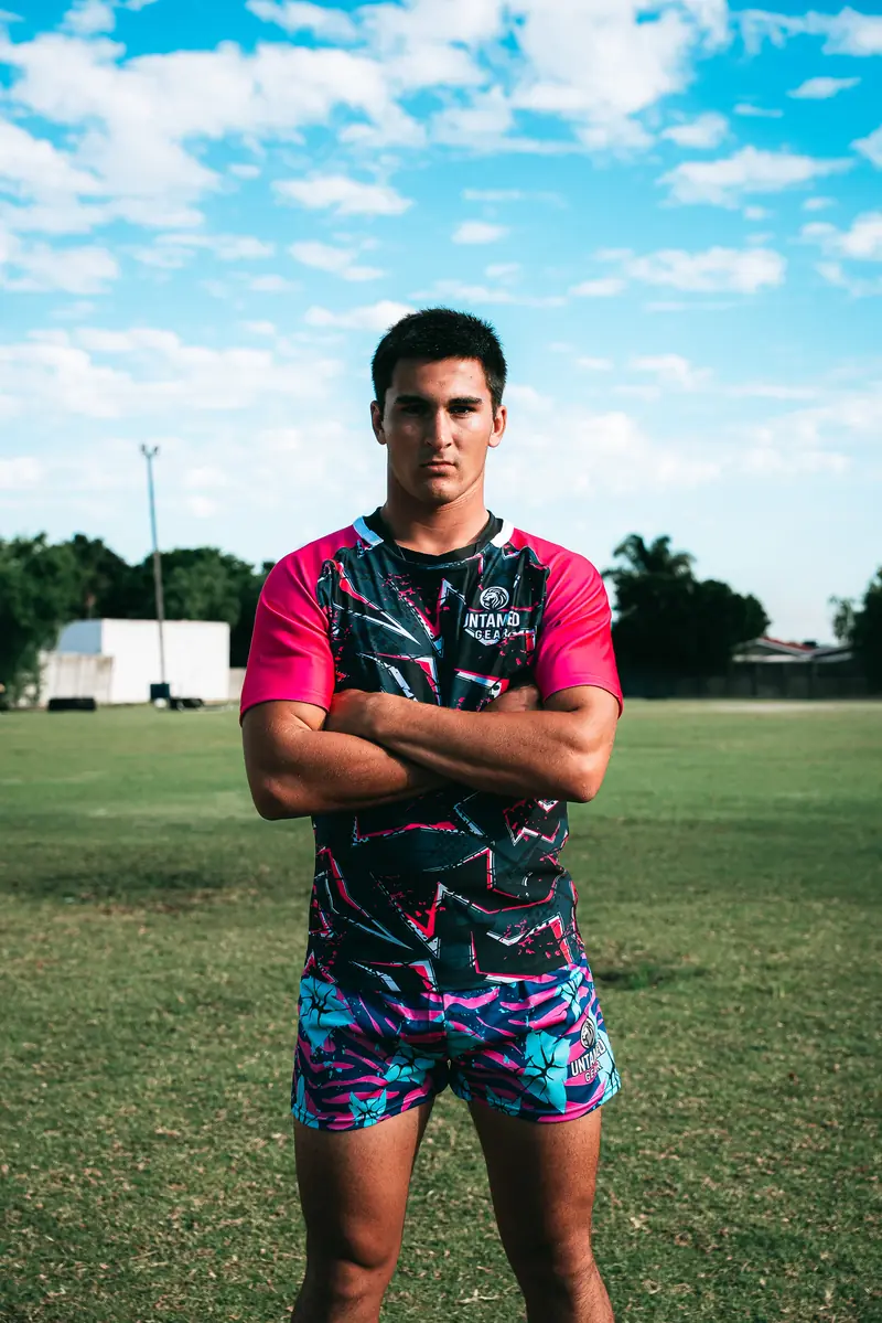 Untamed Gear athlete in geometric print rugby shirt and rugby shorts